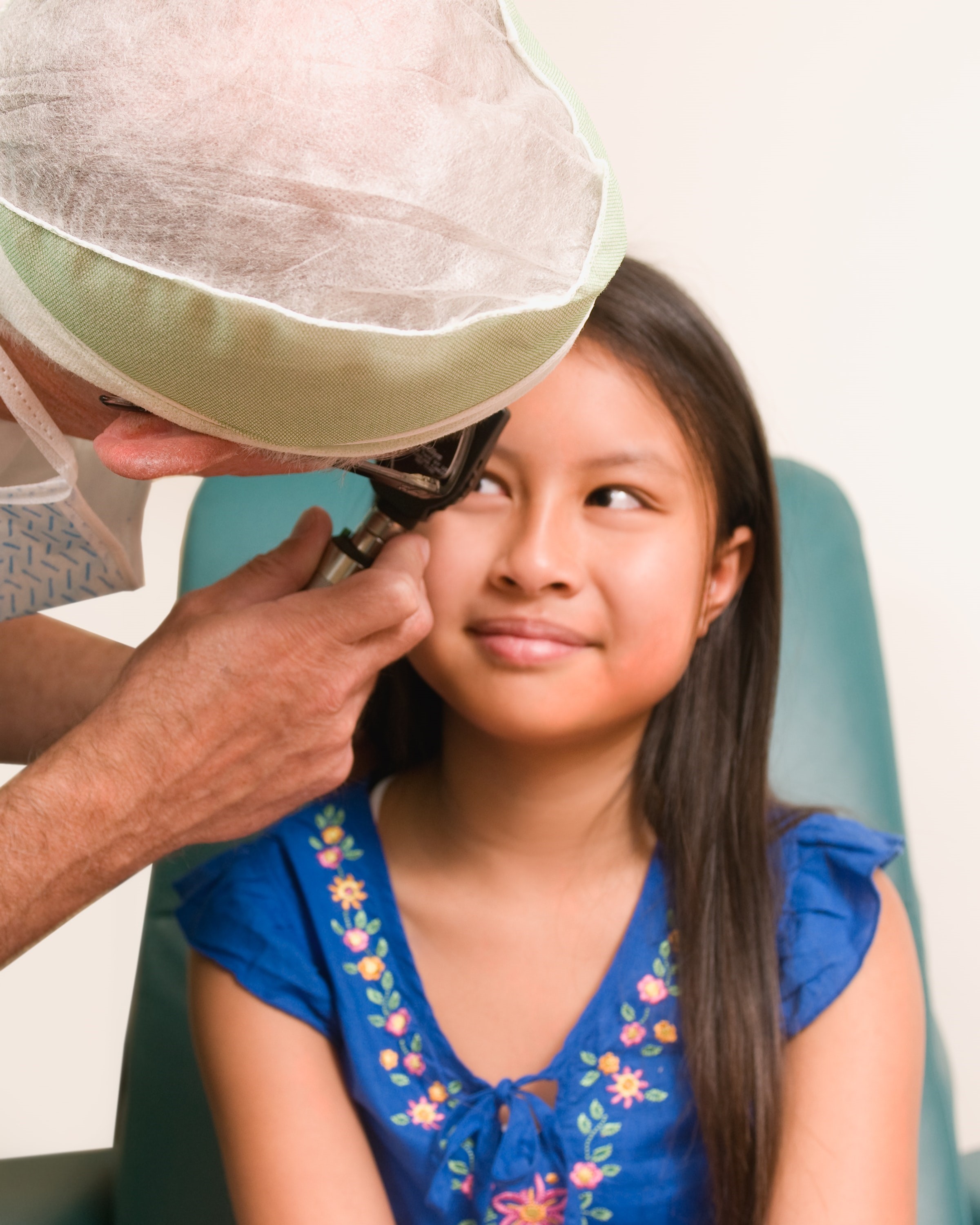 Specialist performing an eye test on a young patient